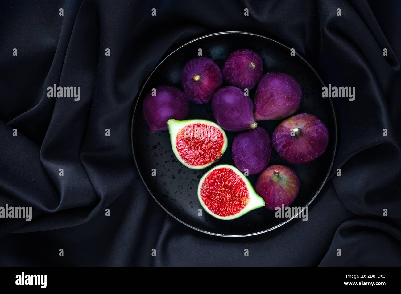 Fresh ripe figs on dark Background. Beautiful blue violet figs with empty copyspace close up. Food photo Stock Photo