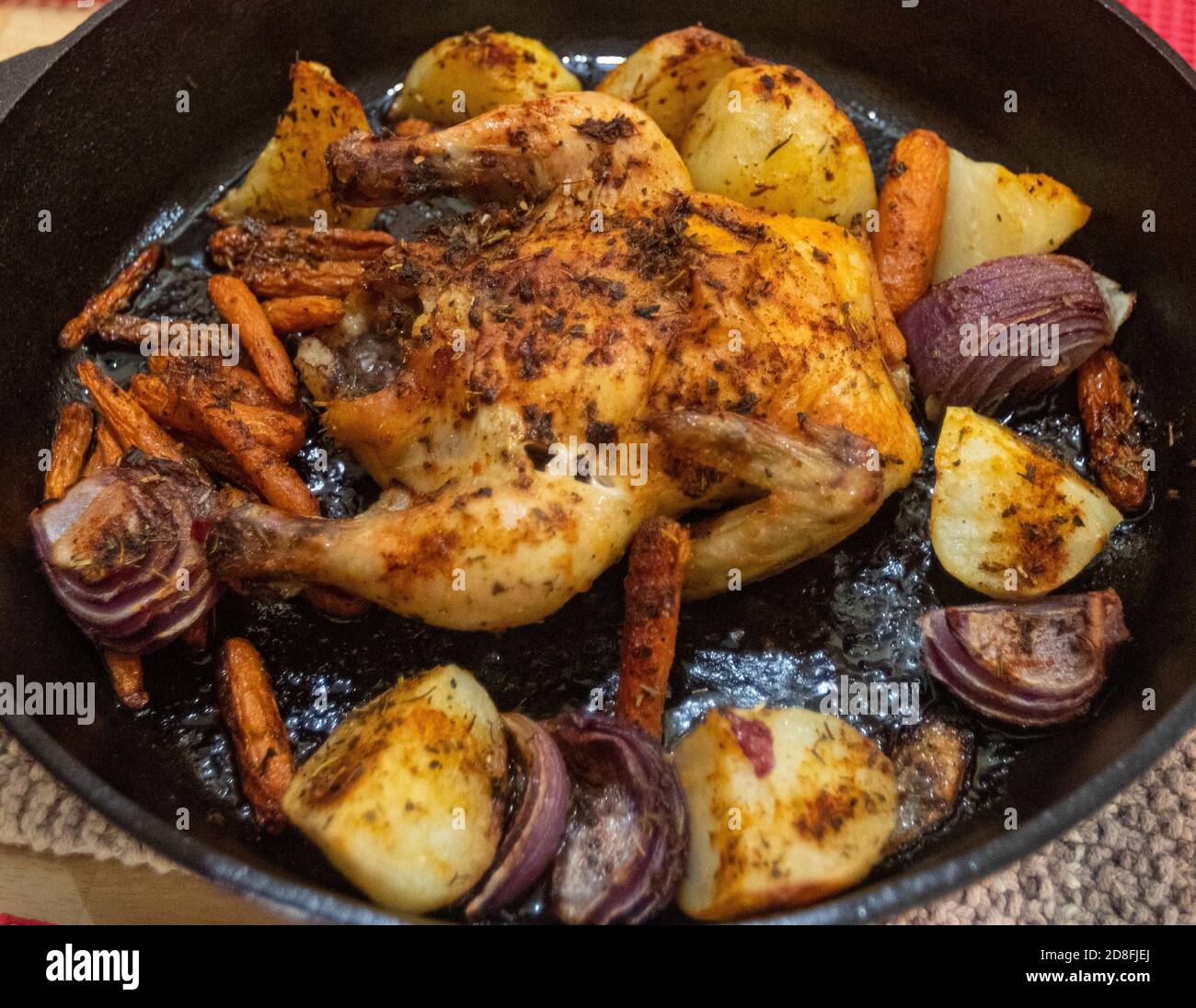 October 29, 2020: A delectable cast-iron skillet-roasted cornish hen sits at a home in San Diego, California on Thursday, October 29th, 2020. The meal and Thanksgiving alternative also includes savory potatoes, crispy carrots, and scrumptious onions. Credit: Rishi Deka/ZUMA Wire/Alamy Live News Stock Photo
