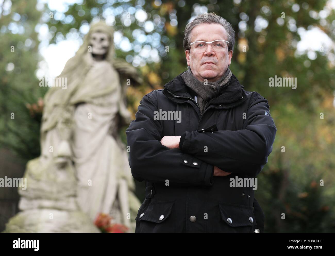 Cologne, Germany. 28th Oct, 2020. Christoph Kuckelkorn, funeral director and carnival president, is standing at a grave in the Melatenfriedhof. (to dpa 'With carnival president Christoph Kuckelkorn at the Melatenfriedhof') Credit: Oliver Berg/dpa/Alamy Live News Stock Photo