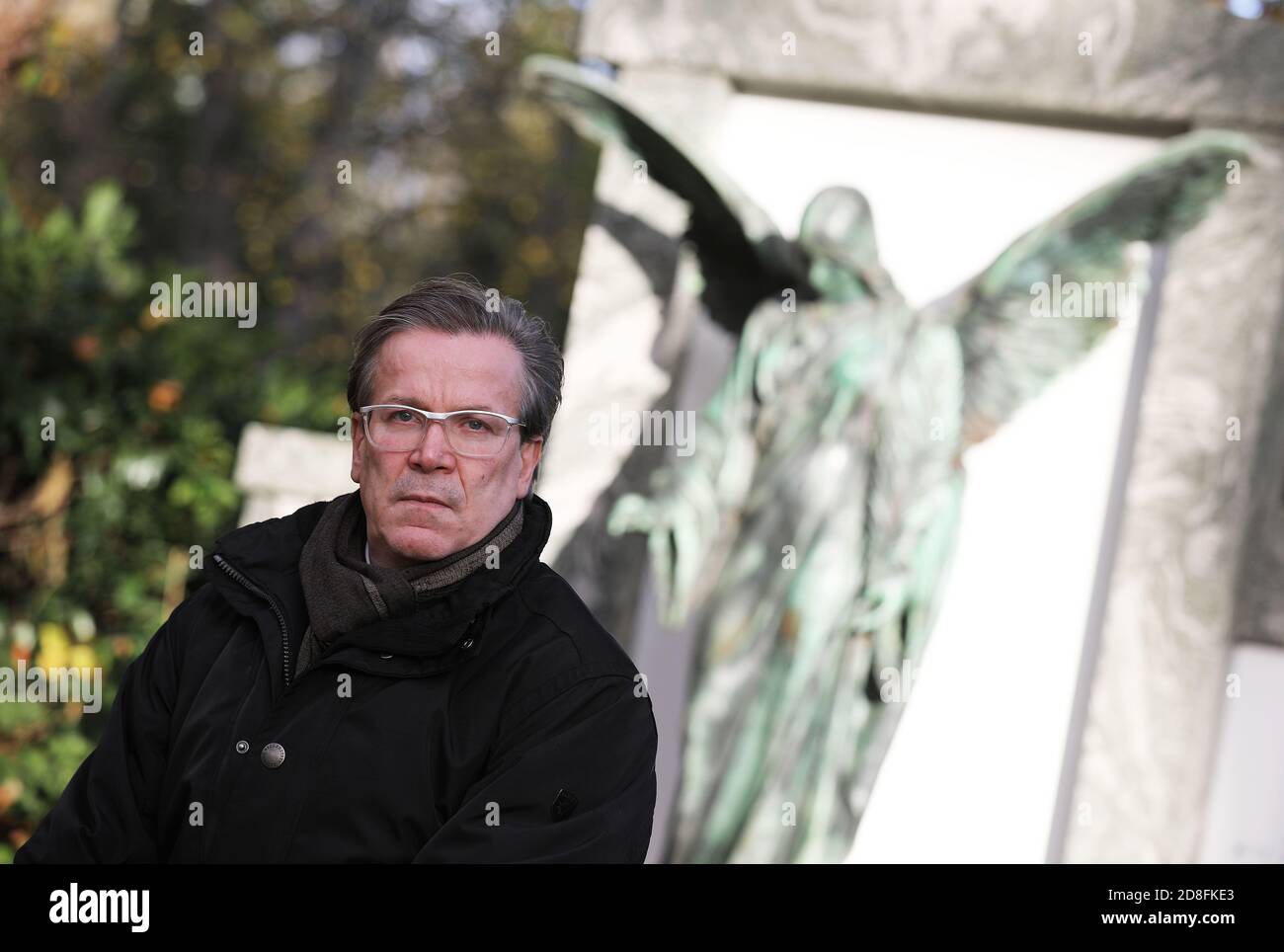 Cologne, Germany. 28th Oct, 2020. Christoph Kuckelkorn, funeral director and carnival president, is sitting at a grave in the Melatenfriedhof. (to dpa 'With carnival president Christoph Kuckelkorn at the Melatenfriedhof') Credit: Oliver Berg/dpa/Alamy Live News Stock Photo