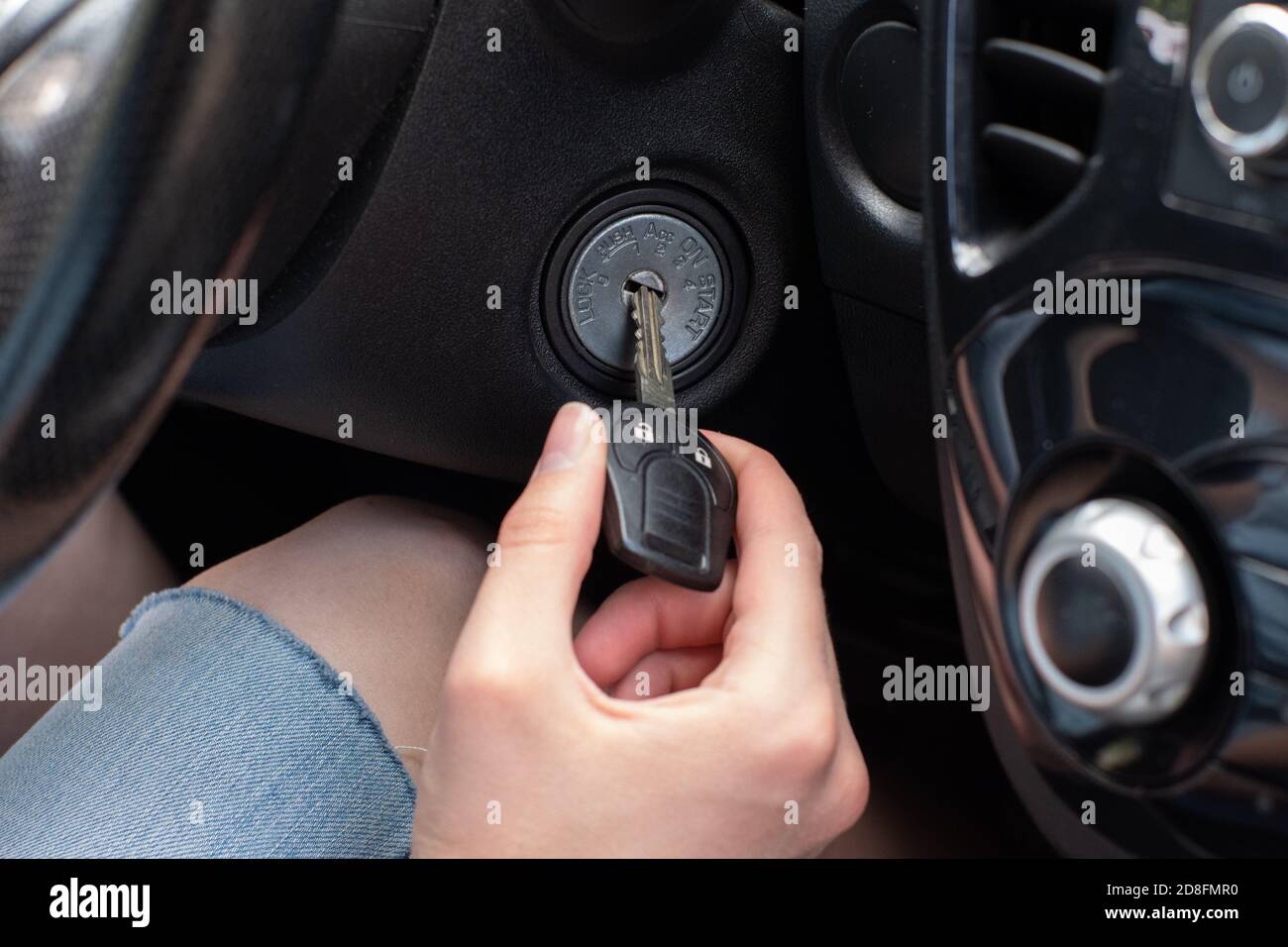 Driver's hand, inserting a car key, turn on the car engine, ready for the trip Stock Photo