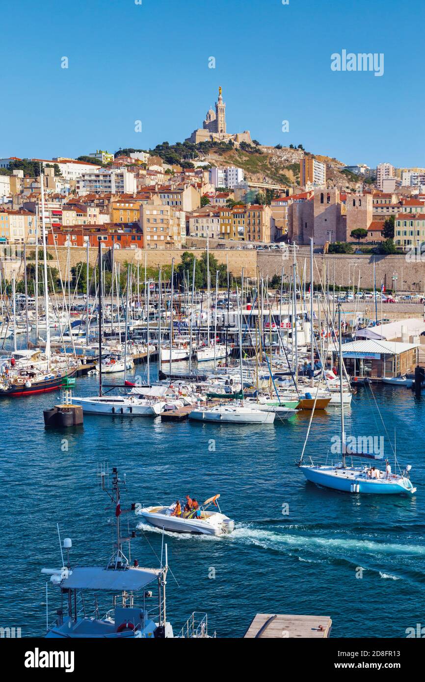 Marseille, Provence-Alpes-Côte d'Azur, France.  View across Vieux-Port, the Old Port, to the 19th century Neo-Byzantine Basilica of Notre-Dame de la G Stock Photo