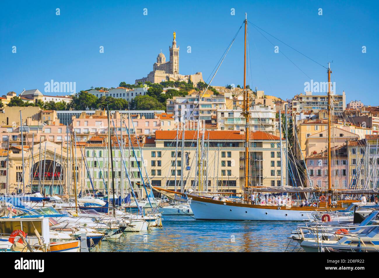 Marseille, Provence-Alpes-Côte d'Azur, France.  View across Vieux-Port, the Old Port, to the 19th century Neo-Byzantine Basilica of Notre-Dame de la G Stock Photo