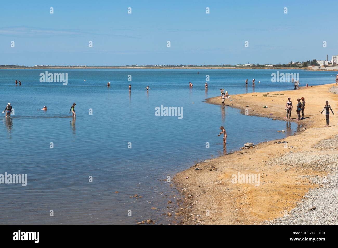 Saki, Crimea, Russia - July 23, 2020: People smear themselves with curative mud on Lake Saki, Crimea Stock Photo