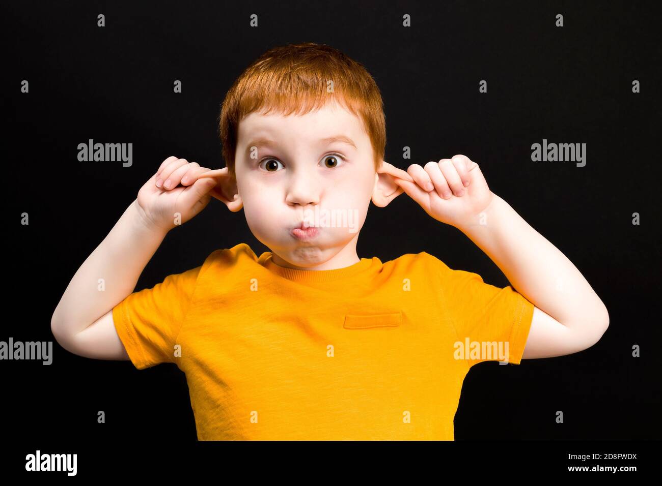 boy holding ears Stock Photo Alamy