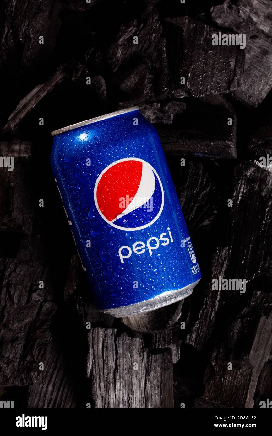 Metal can with pepsi cola on black charcoal background Stock Photo