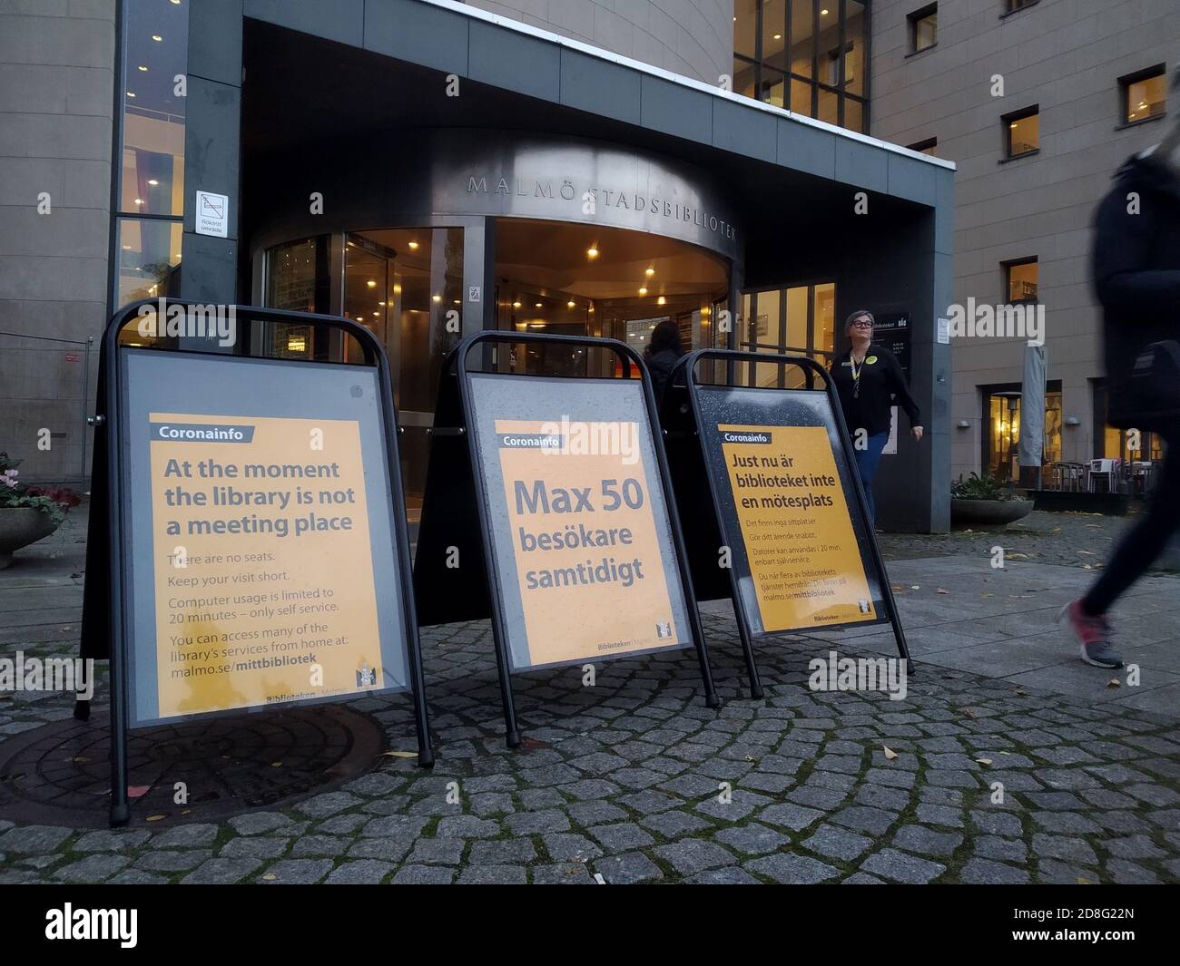 Signs outside the city library in Malmoe restricting the amount of visitors due to Covid-1 Stock Photo