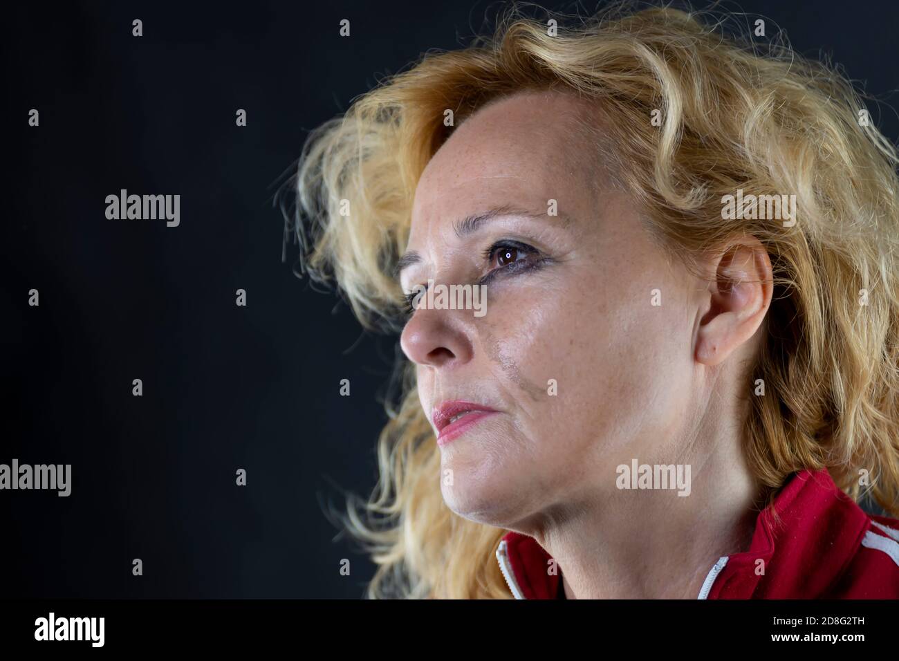 Portrait of a middleaged white woman crying in pain and despair, with