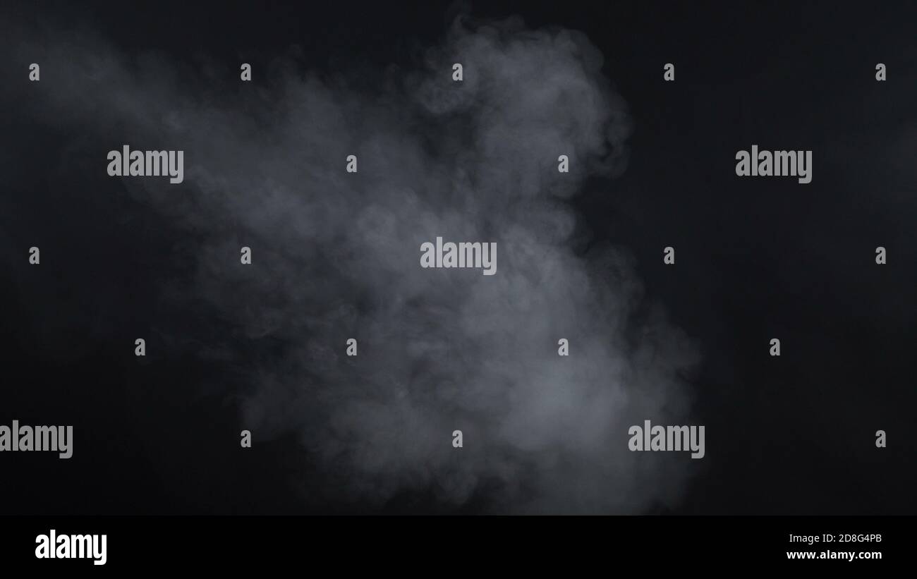 Shooting of white smoke on black background Stock Photo - Alamy