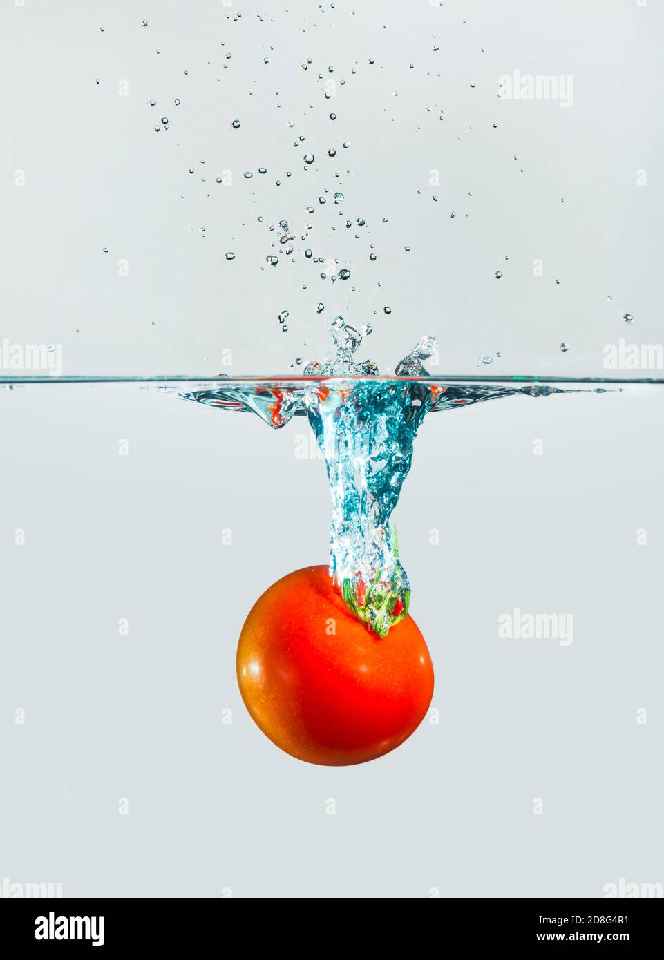 fresh tomatoe splash in water on white background Stock Photo - Alamy