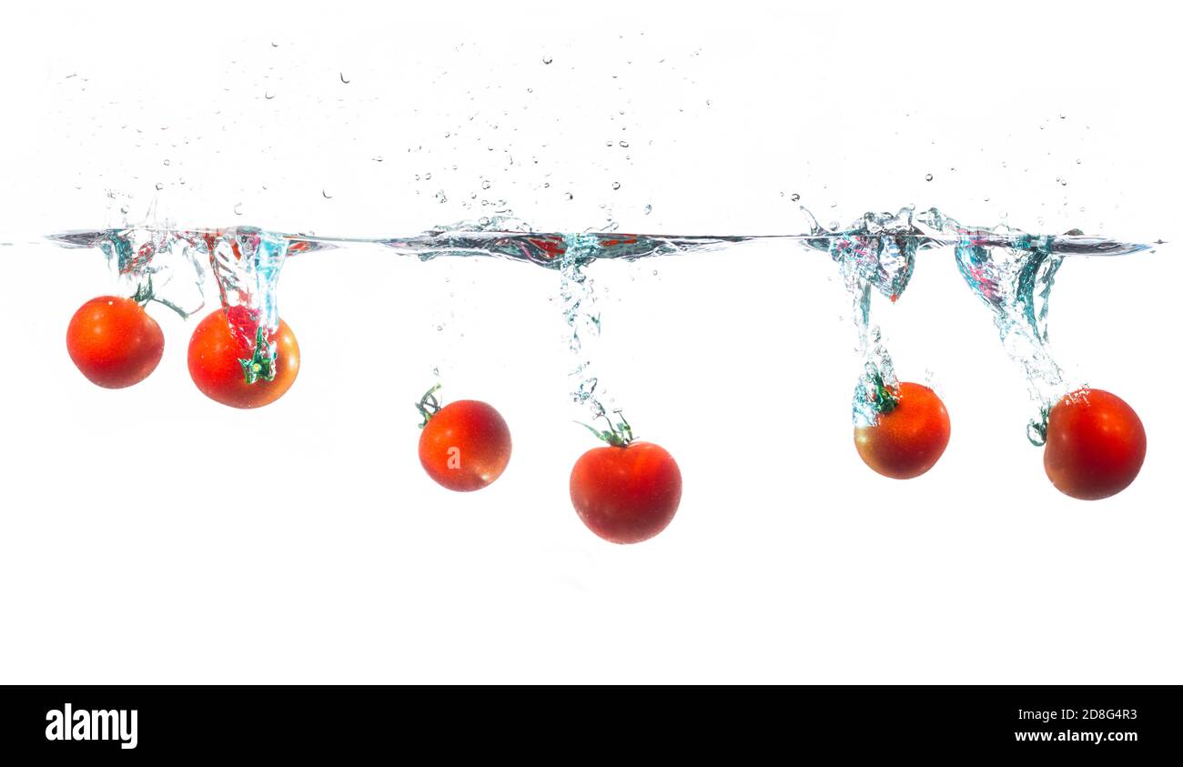 fresh tomatoes splash in water on white background Stock Photo - Alamy