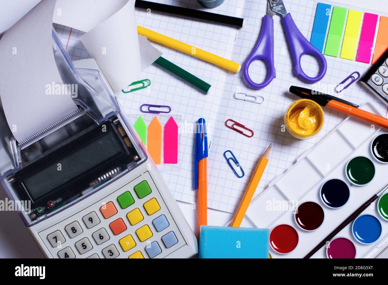 Top view photo of cash register recorder with receipt tape and colorful