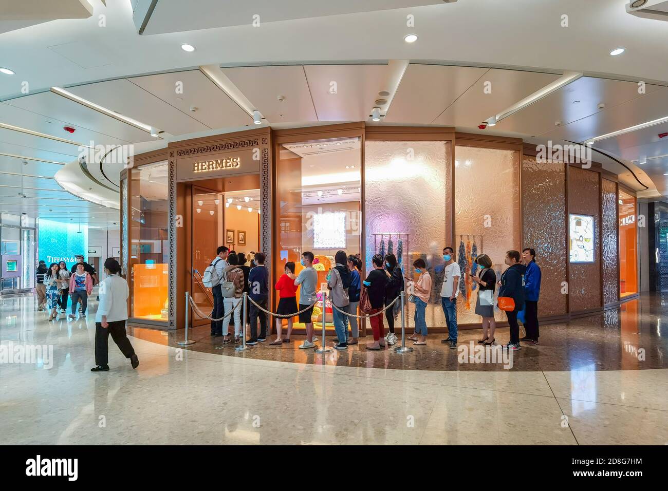 People Queue Up In Front Of Louis Vuitton Shop Stock Photo