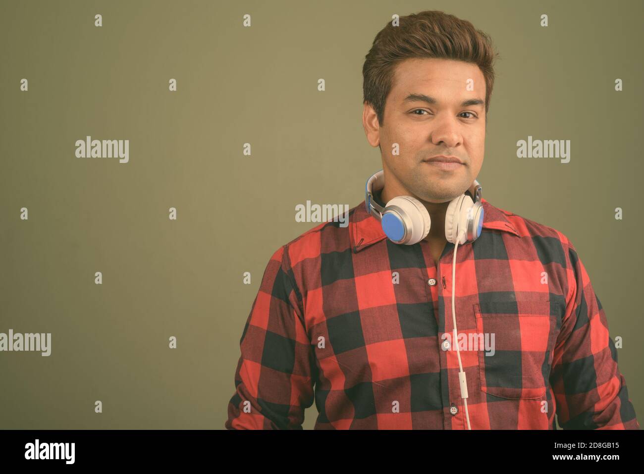 Indian man wearing headphones against colored background Stock Photo ...