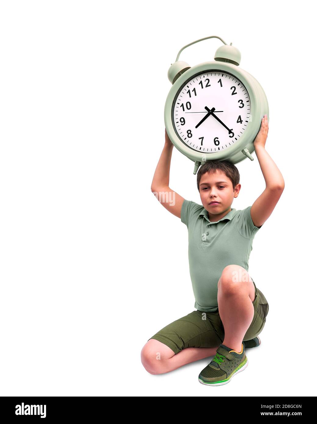 Schools start too early. Little boy with large alarm clock Stock Photo