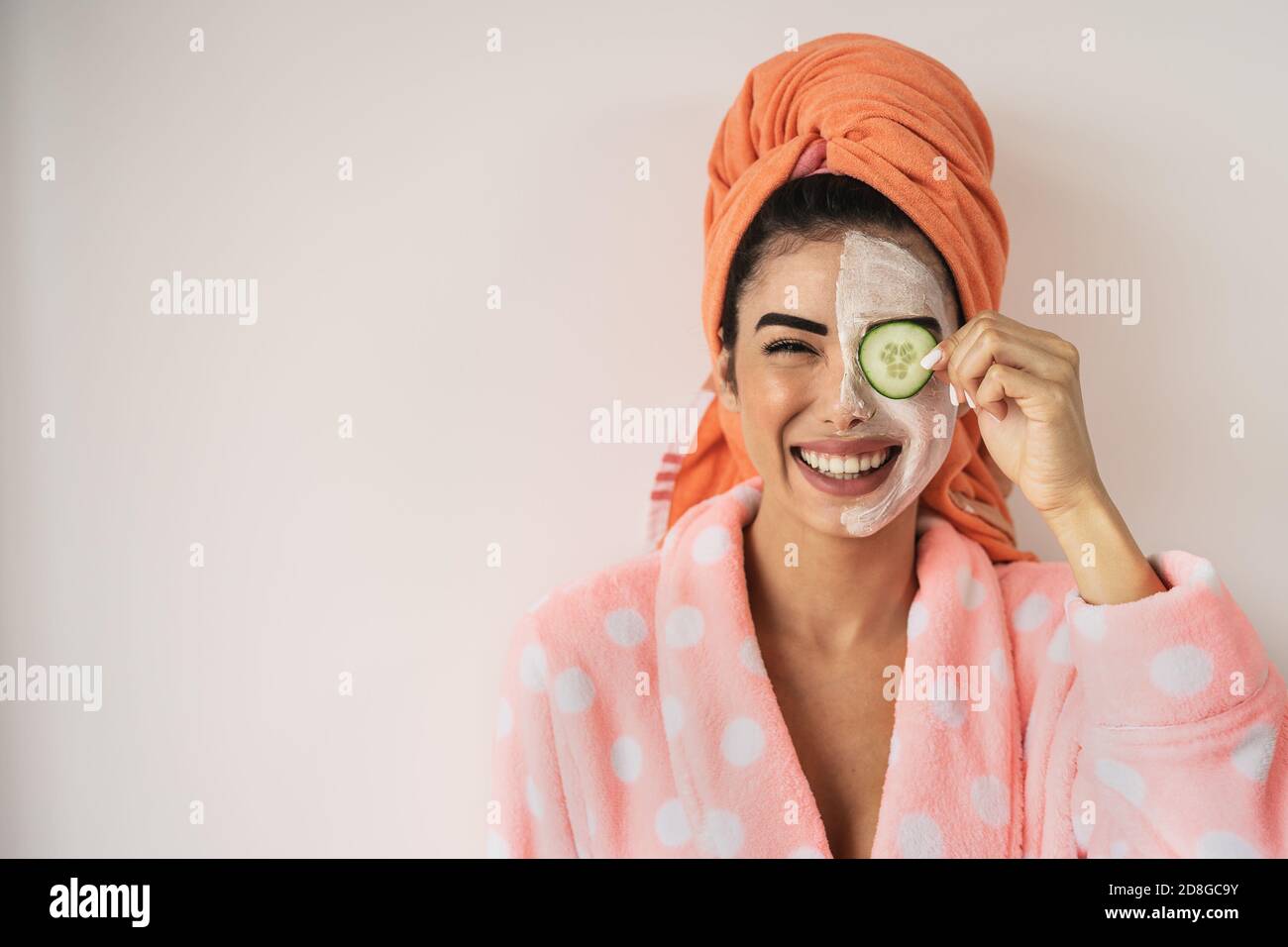 Happy smiling girl applying facial organic cream - Healthy beauty treatment and self care lifestyle concept Stock Photo