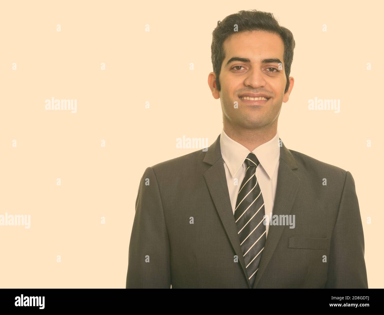 Portrait of happy young Persian businessman in suit smiling Stock Photo ...