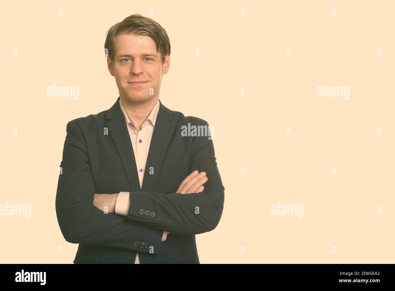 Portrait of young handsome businessman in suit with arms crossed Stock ...