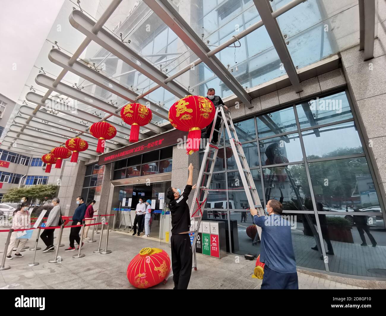 Red lanterns and national flags are seen flying along the Yihe street prior to the National Day of China and Mid-autumn Festival, Wuhan city, central Stock Photo