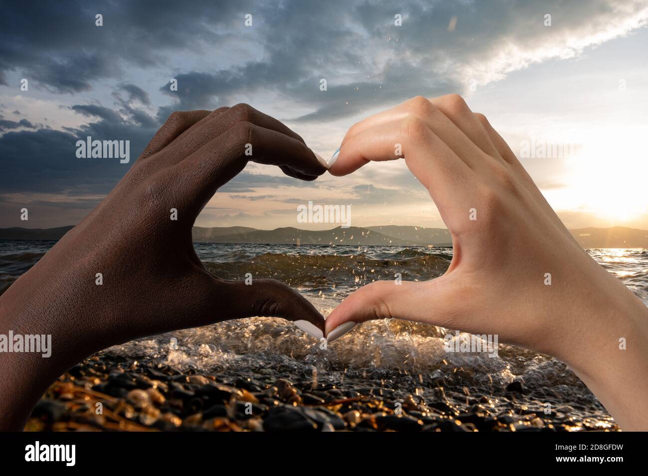 Black and white hands in the form of heart isolated on white background. Interracial friendship stop racism concept Stock Photo