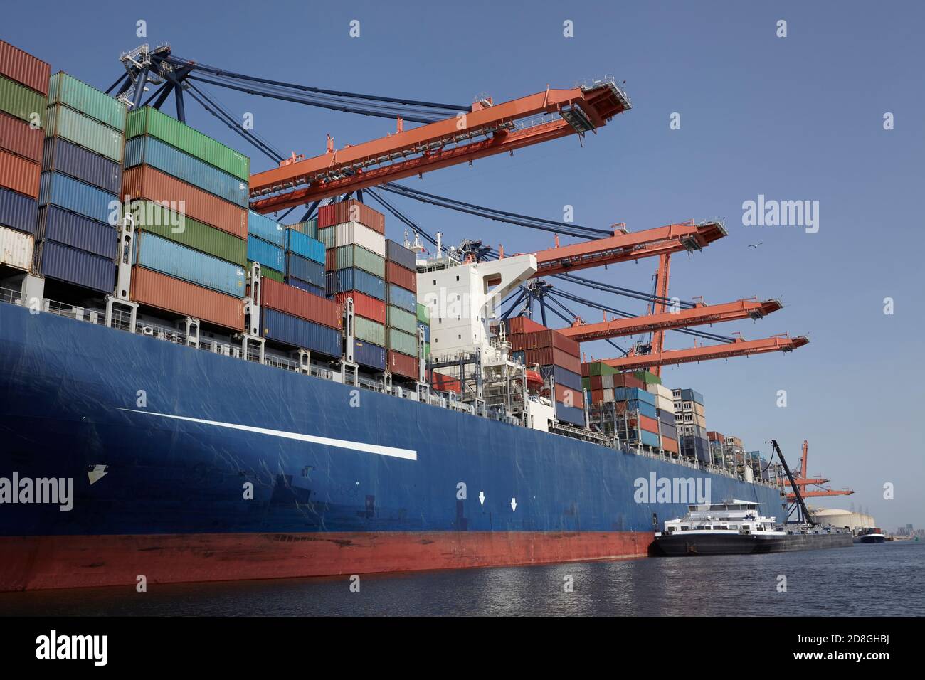 Large harbor cranes loading container ships in the port of Rotterdam ...