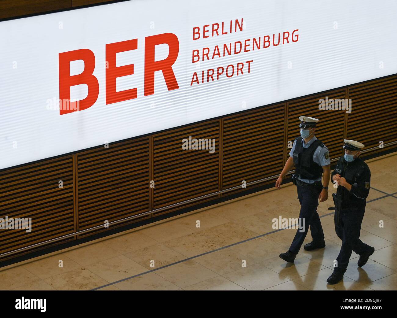 30 October 2020, Brandenburg, Schönefeld: Police officers are walking through Terminal 1 of Berlin Brandenburg Airport 'Willy Brandt' (BER). The opening of the Capital Airport BER is planned for 31.10.2020. Photo: Patrick Pleul/dpa-Zentralbild/dpa Stock Photo