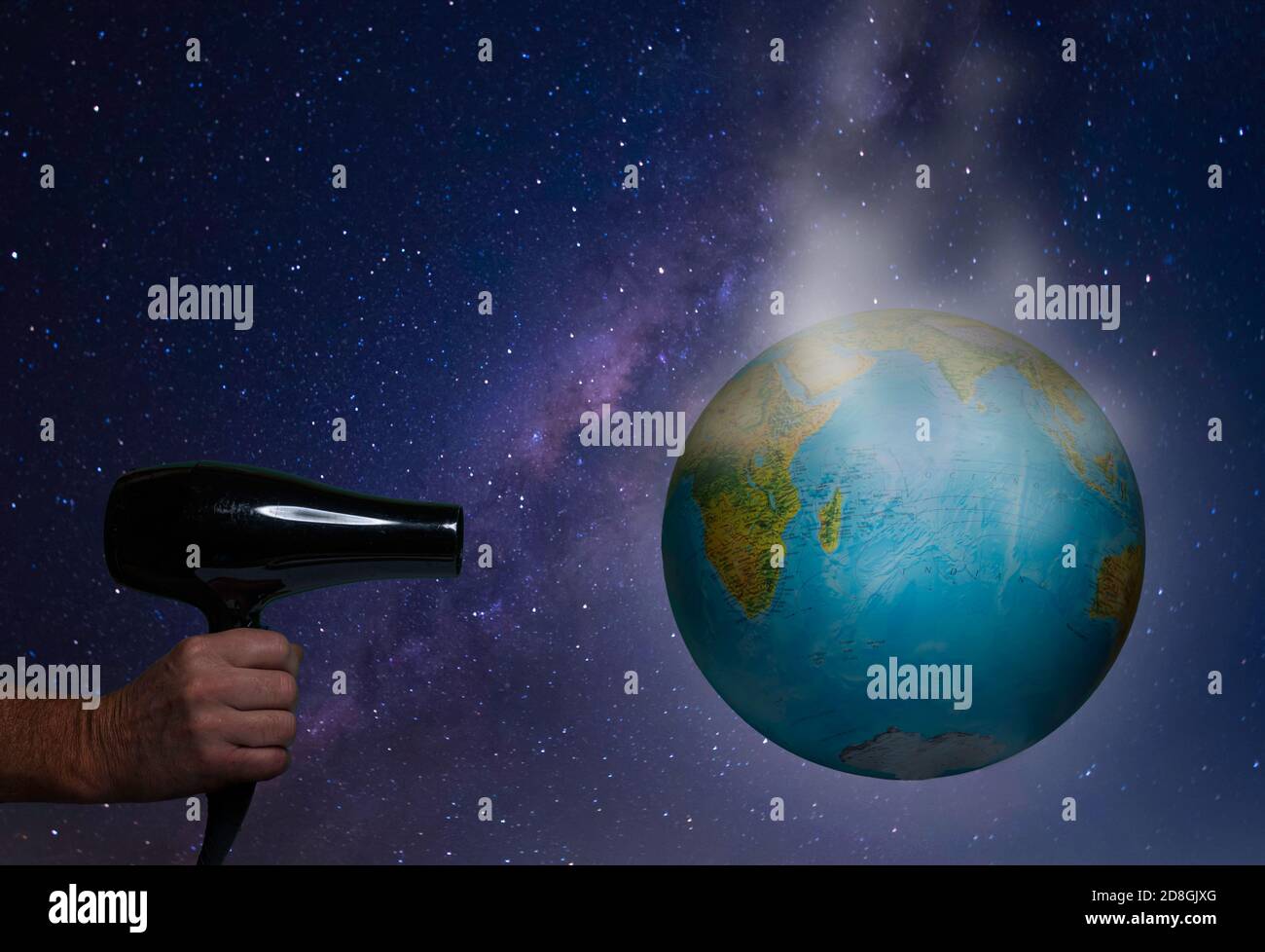 warming the globe with a hair dryer Stock Photo