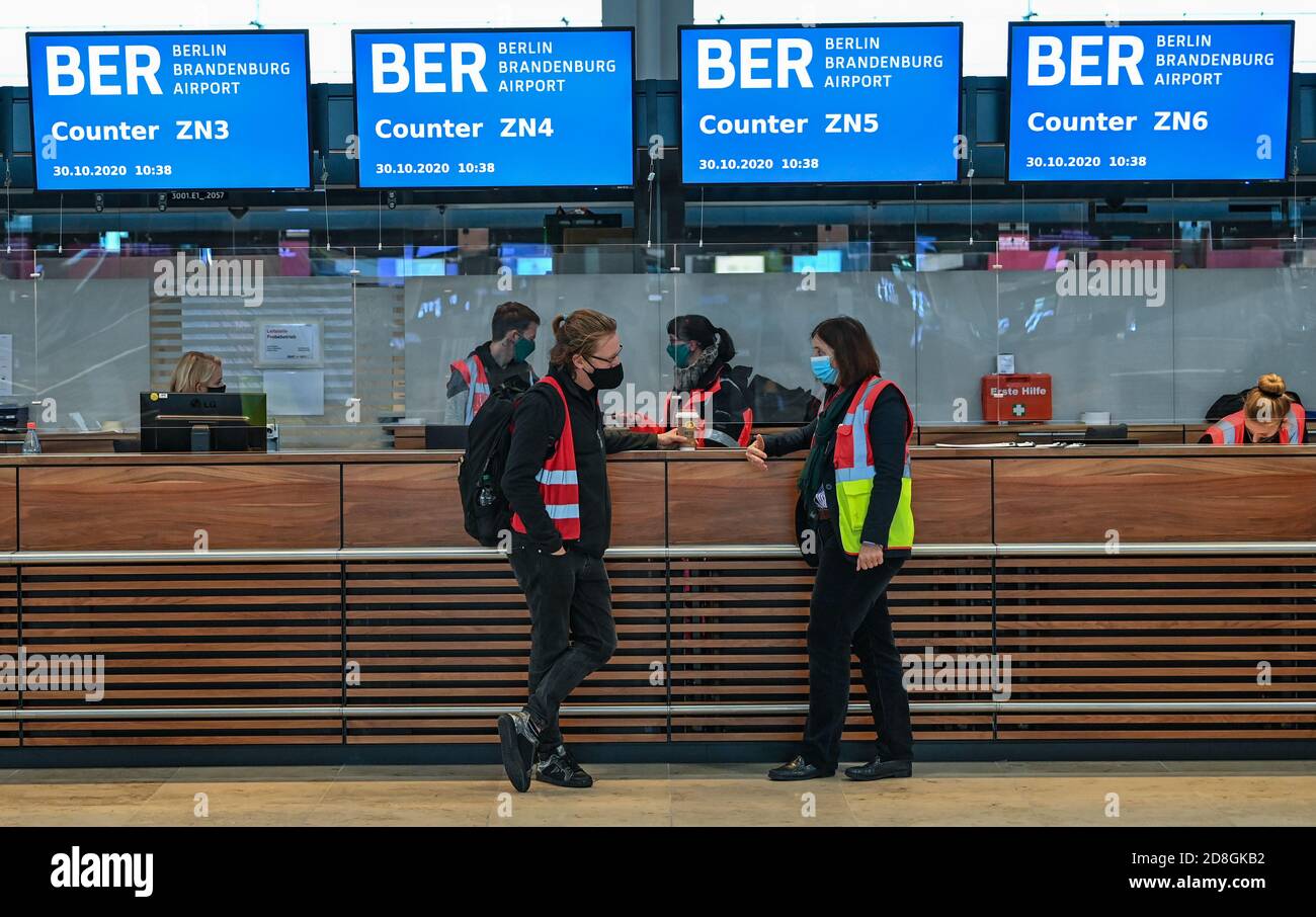 30 October 2020, Brandenburg, Schönefeld: People are standing in front of counters in Terminal 1 of the Capital Airport Berlin Brandenburg 'Willy Brandt' (BER). The opening of the Capital Airport BER is planned for 31.10.2020. Photo: Patrick Pleul/dpa-Zentralbild/dpa Stock Photo