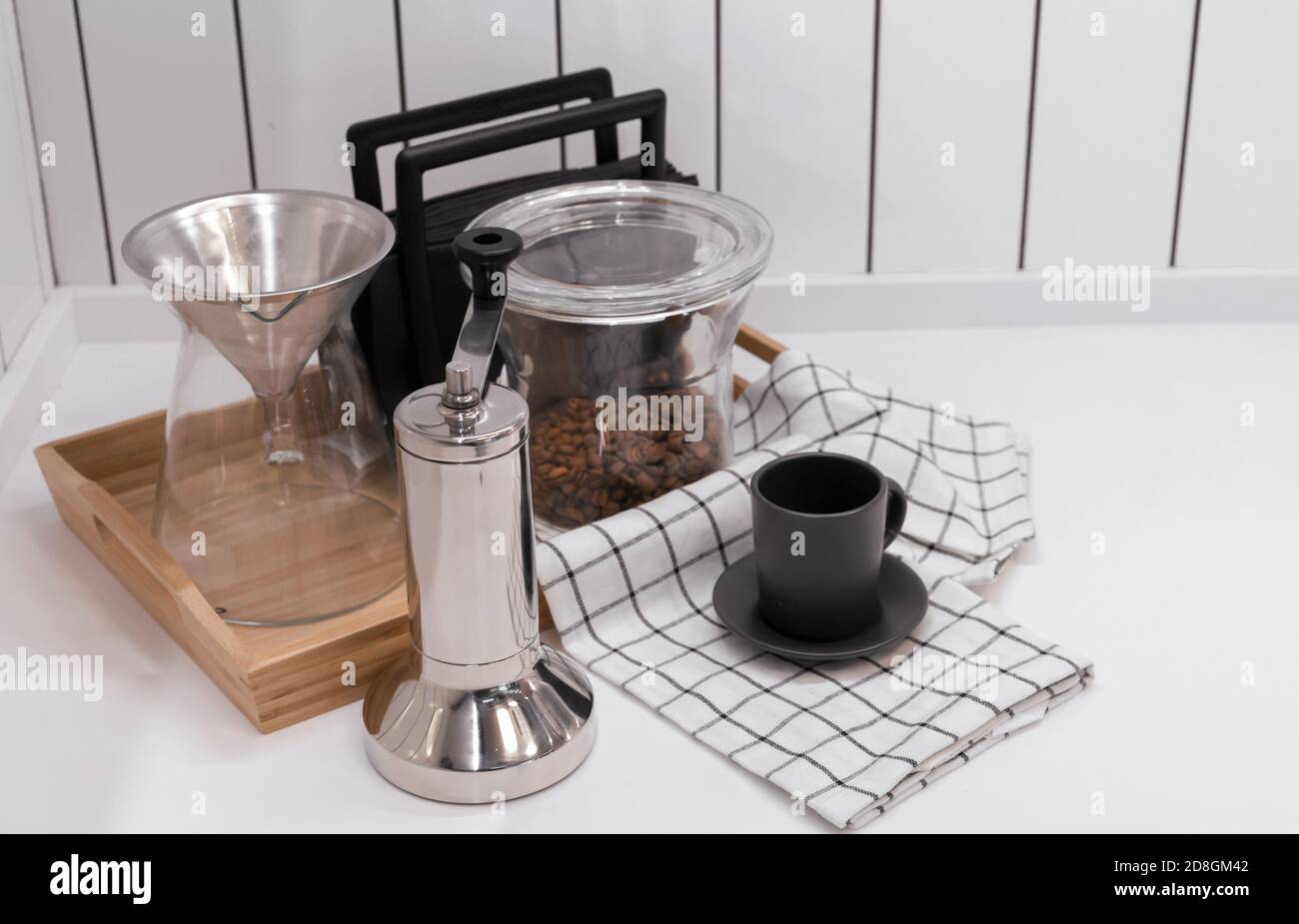 Metal manual coffee grinder. Coffee accessories on the kitchen table. Stock Photo