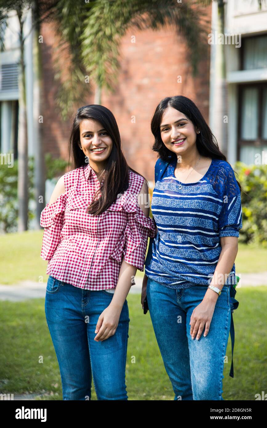 Two Indian asian collage girl students or friends posing for photograph