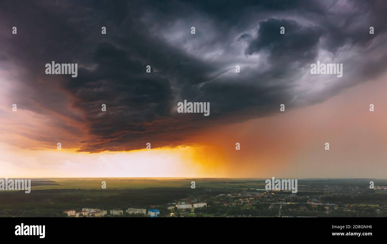 Stormy Sunset Sky Before Rain Above Skyline. Dramatic Cloudy Sky And Flash Light Stock Photo