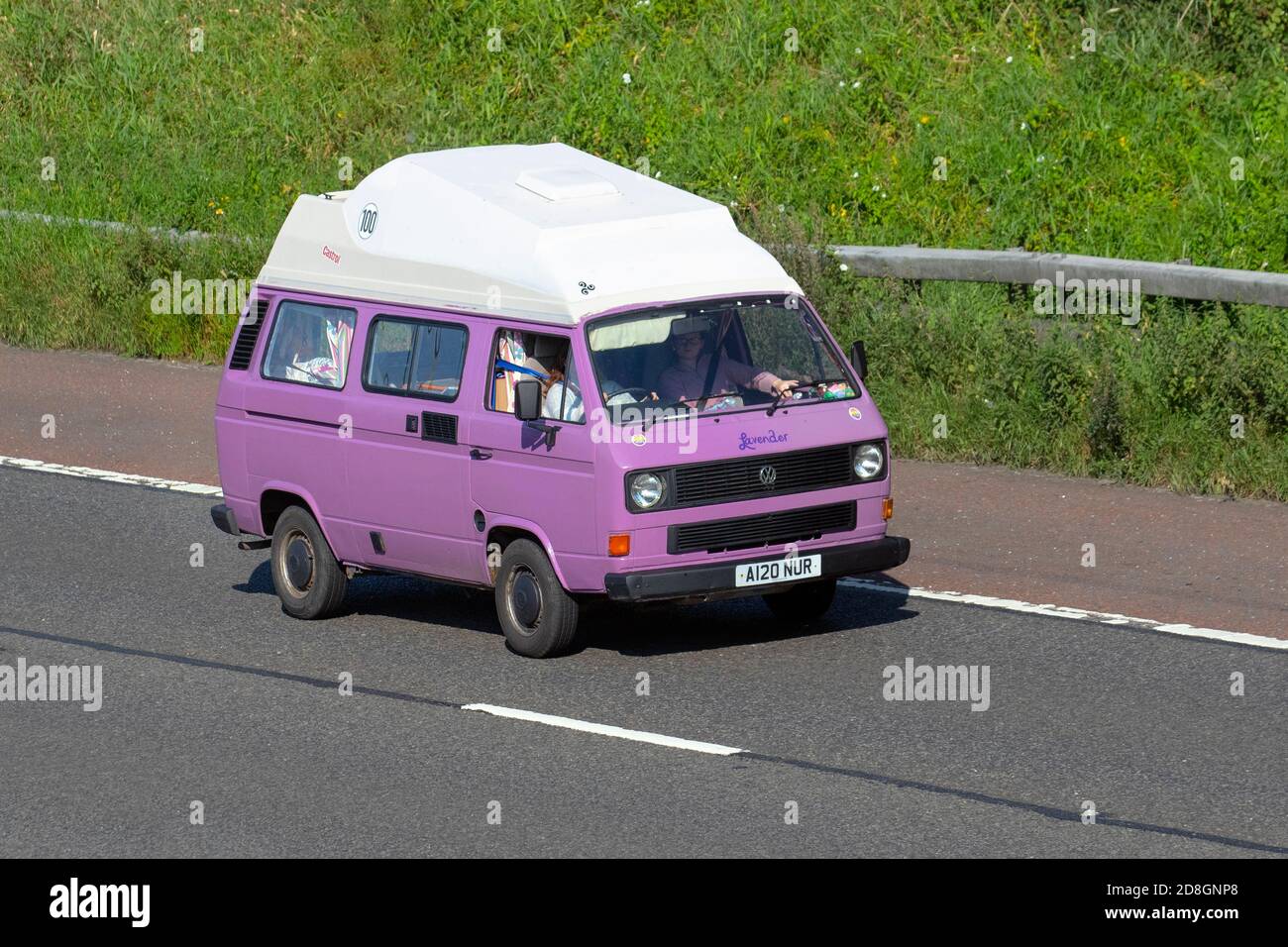 1983 80s mauve purple VW Volkswagens Caravans and Motorhomes, campervans on Britain's roads, RV leisure vehicle, family holidays, caravanette vacations, Touring caravan holiday, high top van conversions, Lavander Vanagon autohome, family life on the road, Stock Photo