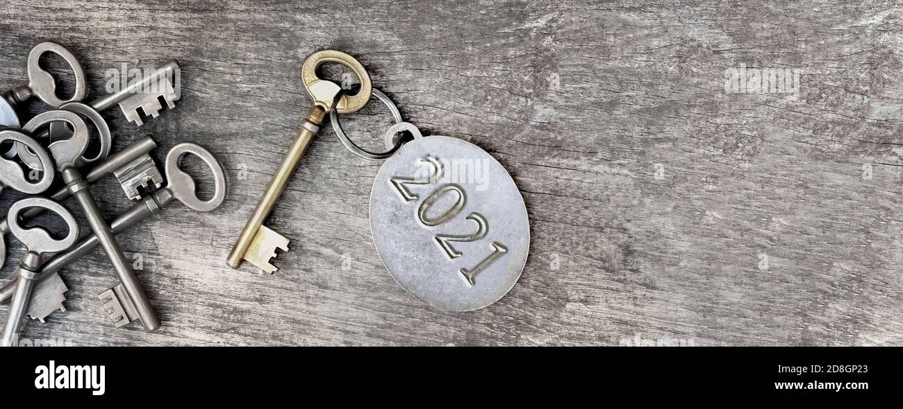 2021 engraved on a ring of an old key on wooden background Stock Photo ...