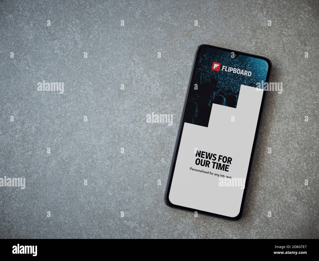 Lod, Israel - July 8, 2020: Flipboard app launch screen with logo on the display of a black mobile smartphone on ceramic stone background. Top view fl Stock Photo