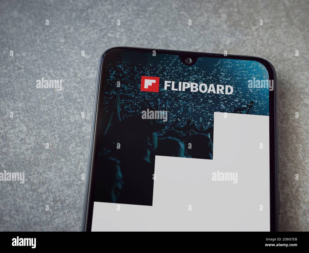 Lod, Israel - July 8, 2020: Flipboard app launch screen with logo on the display of a black mobile smartphone on ceramic stone background. Top view fl Stock Photo