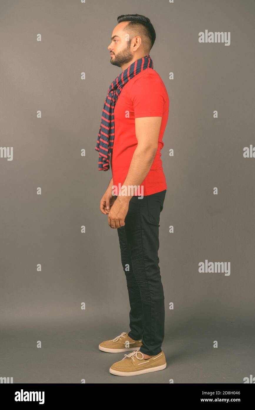 Young bearded Indian man against gray background Stock Photo