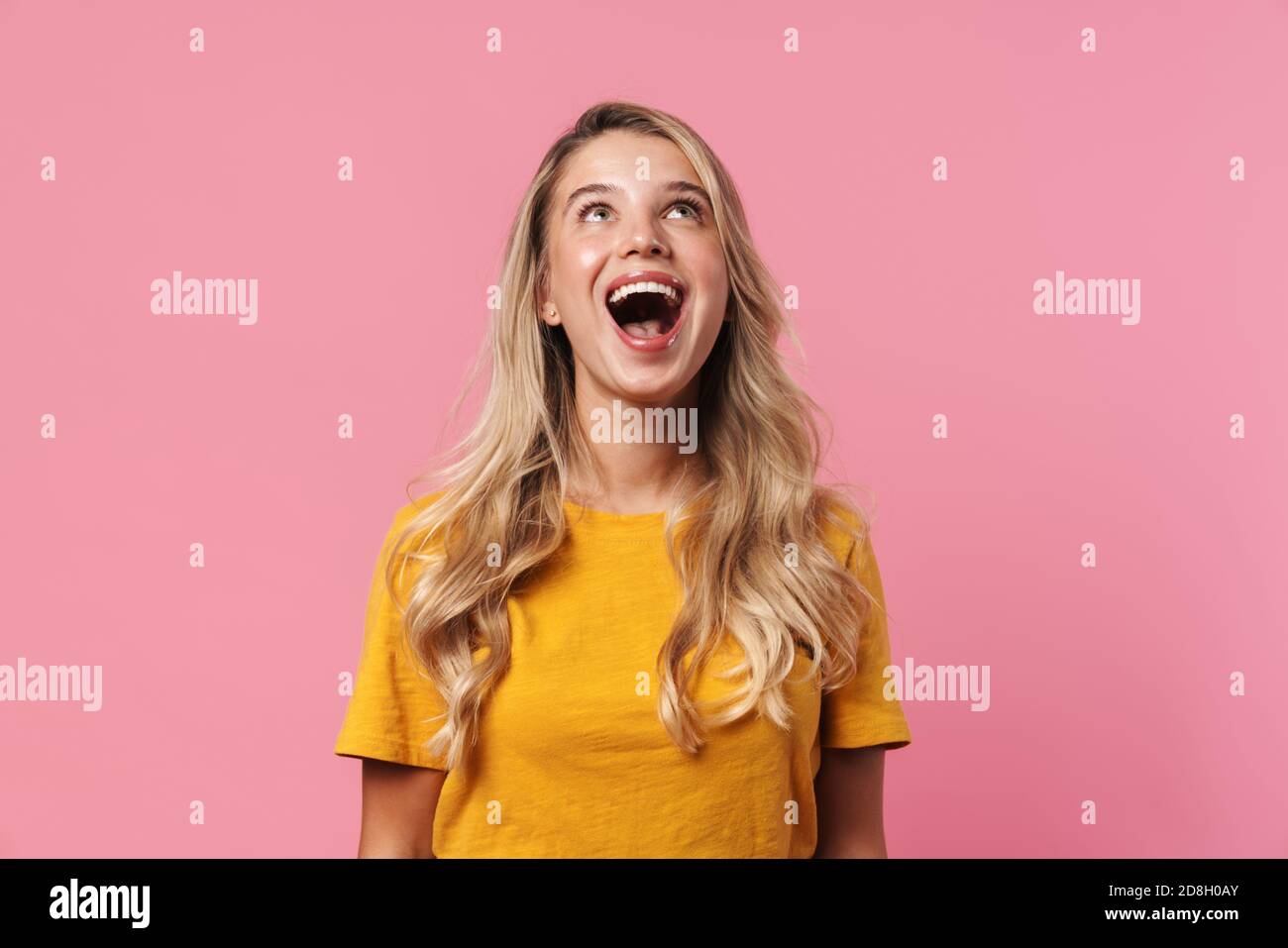 Image of excited blonde girl looking upward and smiling isolated over ...
