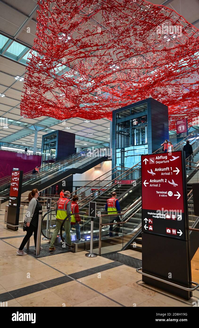 30 October 2020, Brandenburg, Schönefeld: People walk through Terminal 1 of the Capital Airport Berlin Brandenburg 'Willy Brandt' (BER). The opening of the Capital Airport BER is planned for 31.10.2020. Photo: Patrick Pleul/dpa-Zentralbild/ZB Stock Photo