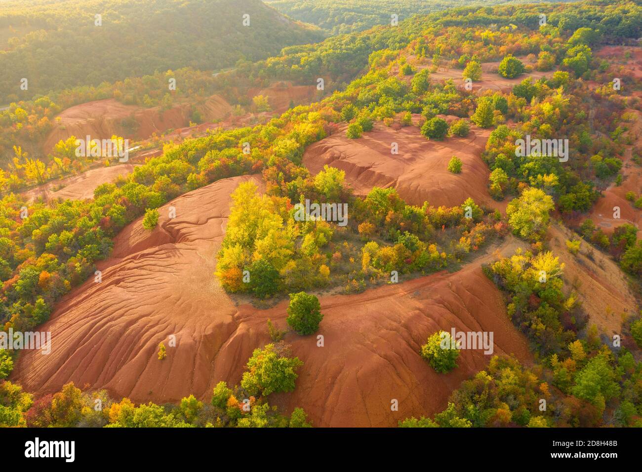 Gant, Hungary - Aerial view of abandoned bauxite mine, bauxite formation. Red and orange colored surface, bauxite texture. Warm fall colors. Stock Photo