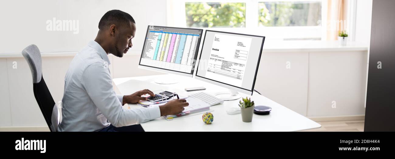 African American Accountant Using Electronic Invoice Software Stock Photo