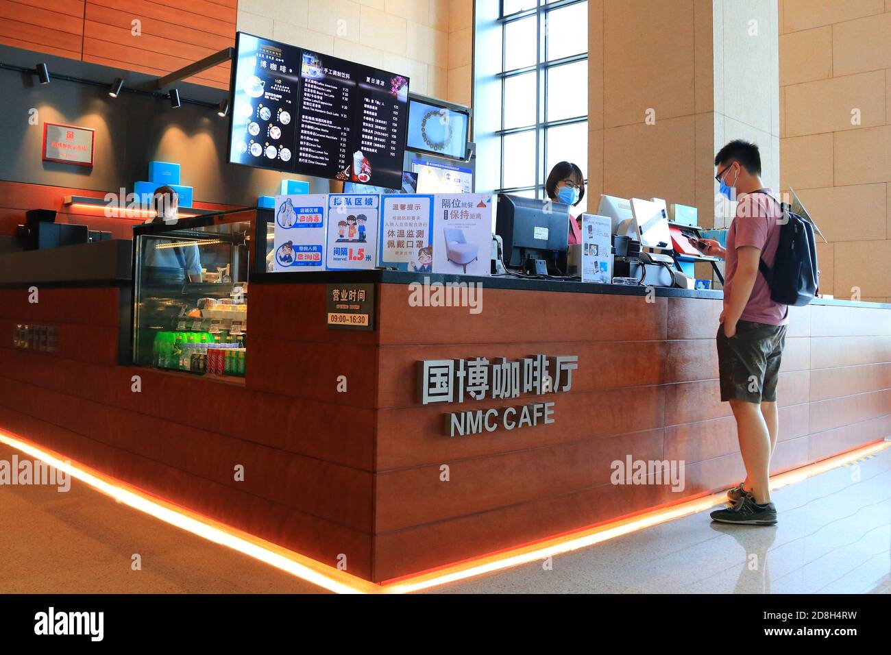 A tourist is buying ice cream in the cafe of National Museum of China