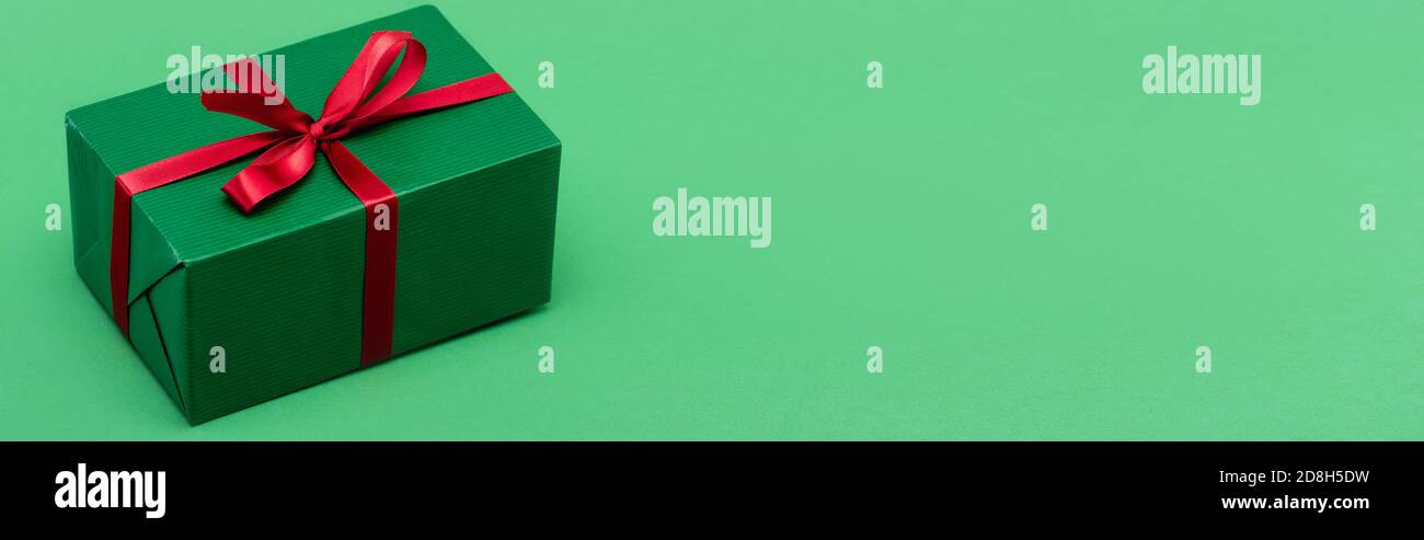 Gifts Header website header of gift box with red ribbon on green background with ...