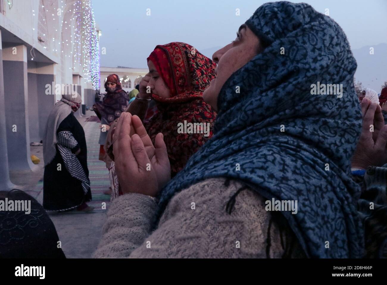 Srinagar, India. 30th Oct, 2020. Kashmiri Muslim devotees look towards a cleric (not seen in the picture) displaying the holy relic believed to be the whisker from the beard of the Prophet Mohammed, at Hazratbal shrine on the Eid-e-Milad, or the birth anniversary of Prophet Mohammad in Srinagar. (Photo by Adil Abass/Pacific Press) Credit: Pacific Press Media Production Corp./Alamy Live News Stock Photo