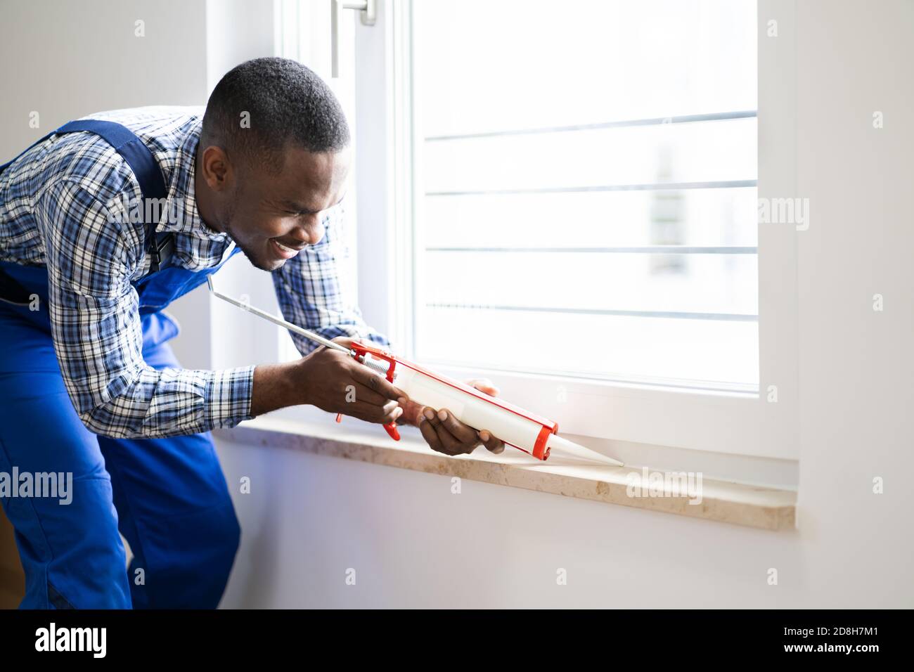 Caulk Sealant Application. Silicone Window Seal And Waterproofing Stock Photo