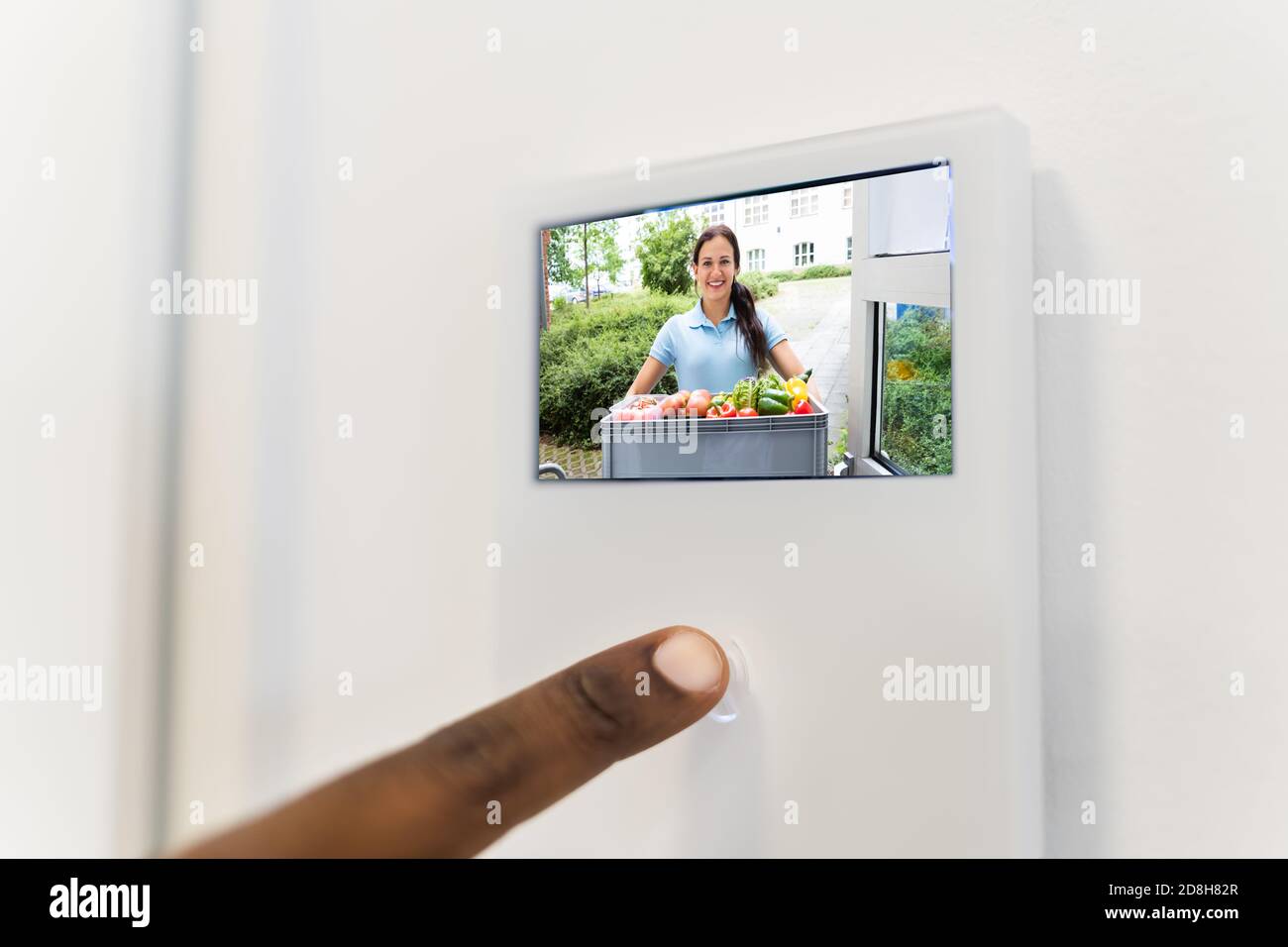 African Man Using Video Intercom Entrance Safety System Stock Photo