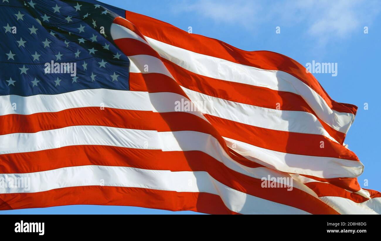 American flag flying in the wind at sunny day Stock Photo - Alamy