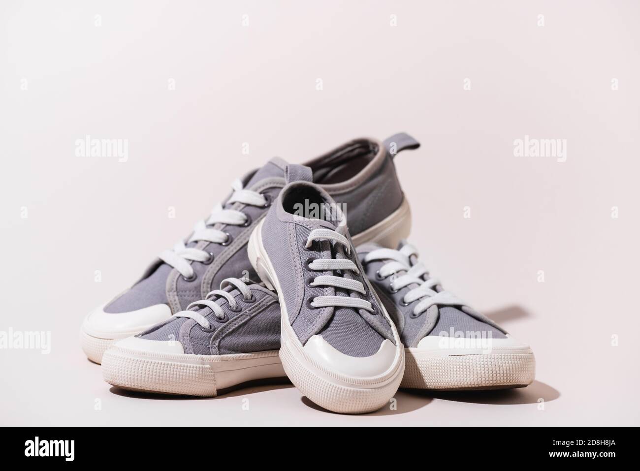 grey casual sneakers on white background Stock Photo