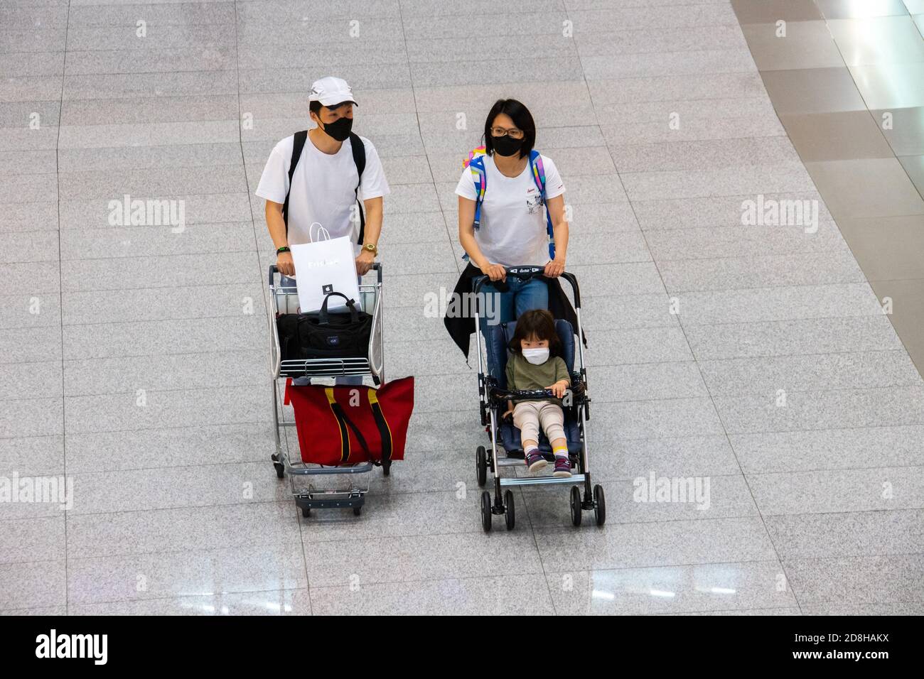 Young family wearing masks during the COVID pandemic Seoul Station, Seoul, South Korea Stock