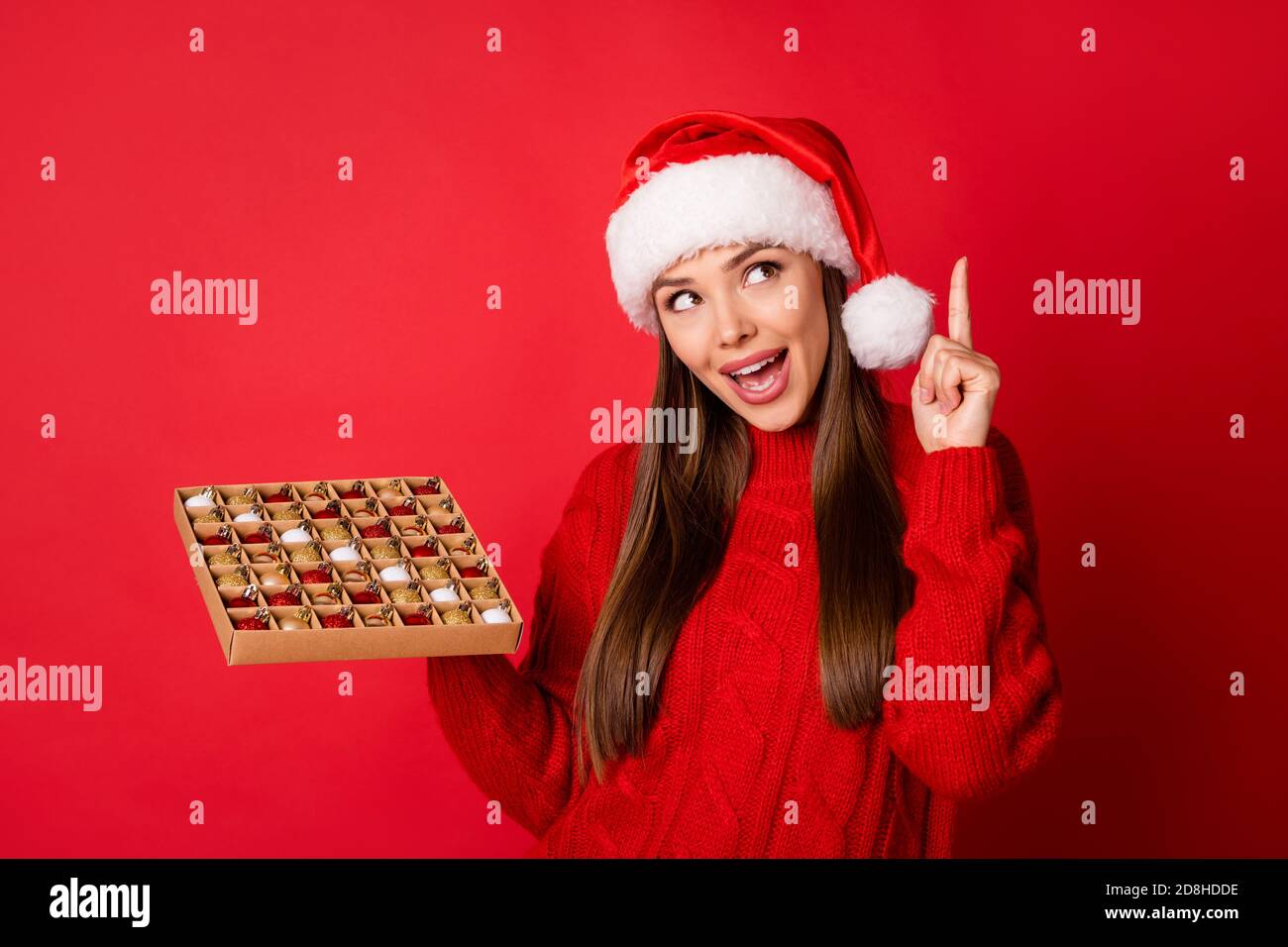 Close-up portrait of her she nice attractive charming cheerful creative girl holding in hands choosing tree balls box newyear occasion isolated over Stock Photo