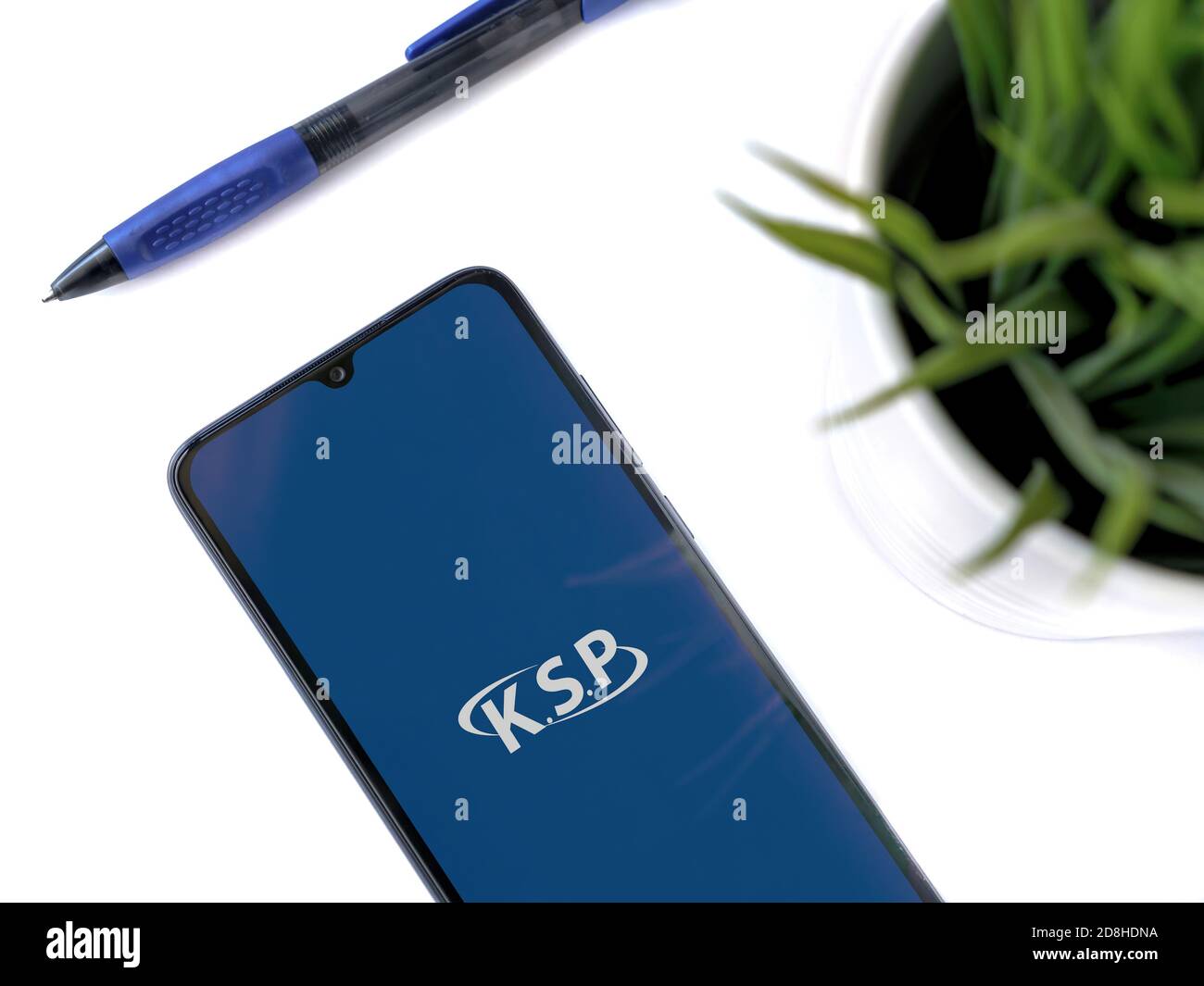 Lod, Israel - July 8, 2020: Modern minimalist office workspace with black mobile smartphone with KSP app launch screen with logo on white background. Stock Photo